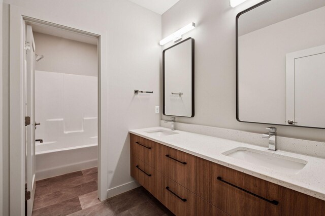 bathroom with a sink and double vanity