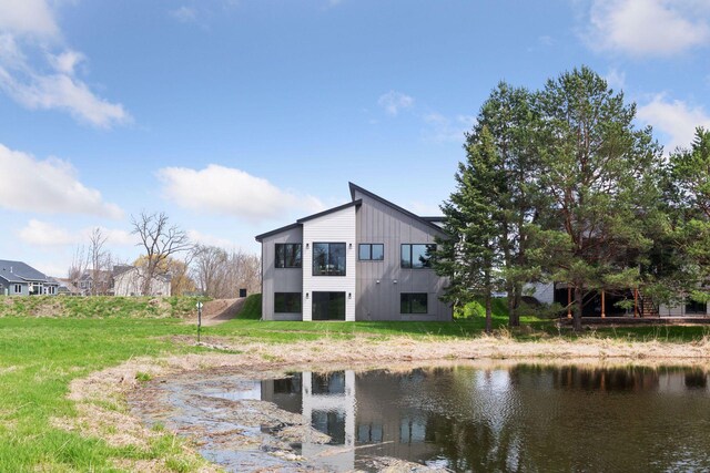 rear view of property featuring a water view
