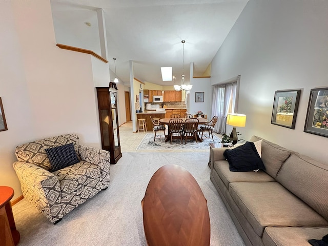 living room with an inviting chandelier, light carpet, baseboards, and high vaulted ceiling