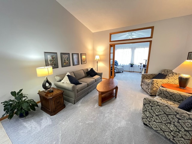 living room featuring carpet flooring, baseboards, ceiling fan, and high vaulted ceiling