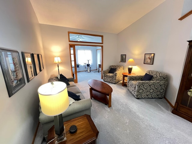 living area featuring carpet floors, a ceiling fan, and baseboards