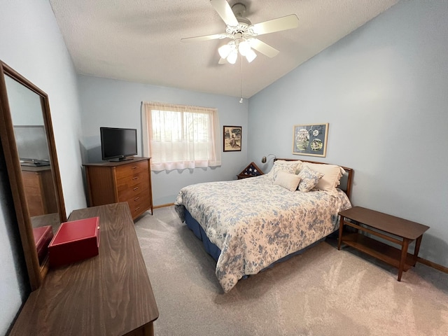 bedroom with light carpet, baseboards, lofted ceiling, and ceiling fan