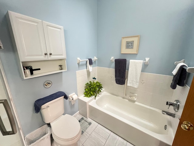 bathroom featuring toilet and a garden tub