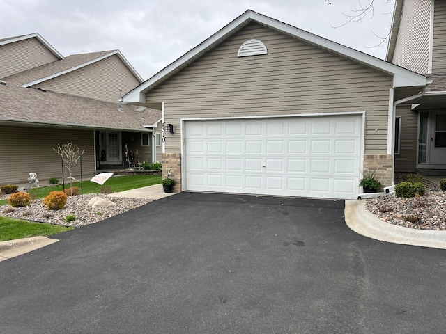 view of front of house featuring aphalt driveway and an attached garage