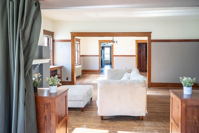 560 7th St, Red Wing, MN 55066 - living area featuring baseboards, radiator, a notable chandelier, and wood finished floors