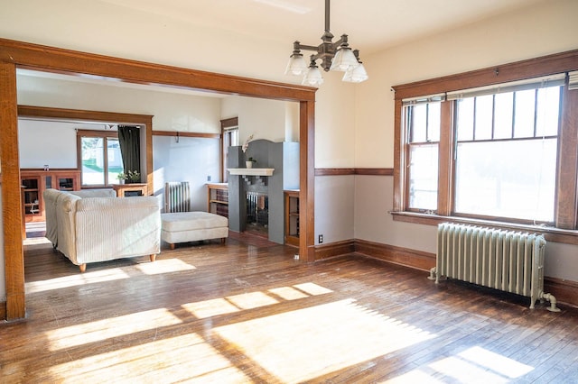 560 7th St, Red Wing, MN 55066 - living room with radiator, a fireplace, baseboards, and hardwood / wood-style floors