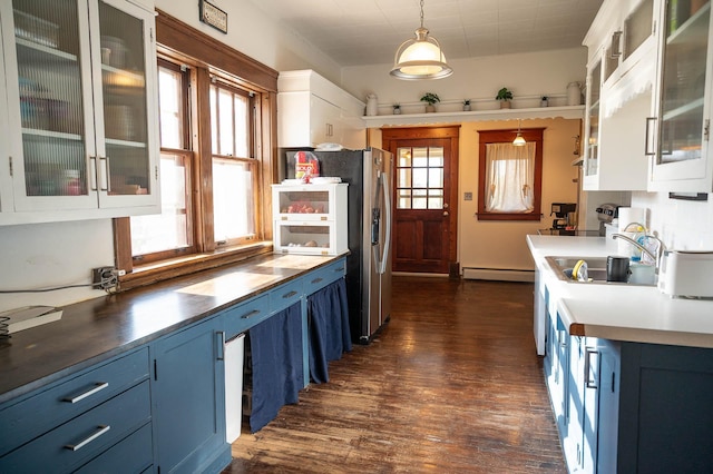 560 7th St, Red Wing, MN 55066 - kitchen featuring a sink, blue cabinets, dark wood-type flooring, white cabinetry, and baseboard heating