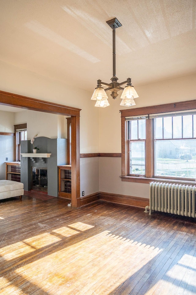 560 7th St, Red Wing, MN 55066 - interior space featuring baseboards, radiator, hardwood / wood-style floors, and a ceiling fan