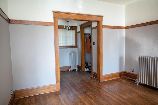 560 7th St, Red Wing, MN 55066 - empty room featuring radiator, wood finished floors, and baseboards