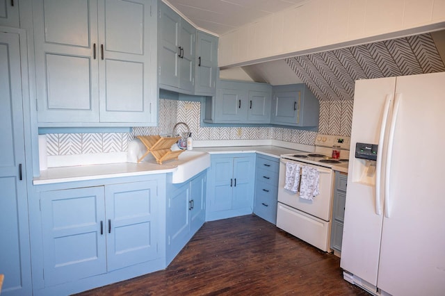 560 7th St, Red Wing, MN 55066 - kitchen with white appliances, backsplash, dark wood finished floors, light countertops, and a sink