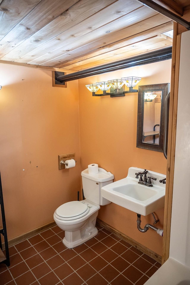 560 7th St, Red Wing, MN 55066 - bathroom with wood ceiling, toilet, a sink, tile patterned floors, and baseboards