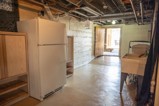 560 7th St, Red Wing, MN 55066 - unfinished below grade area featuring a sink and freestanding refrigerator