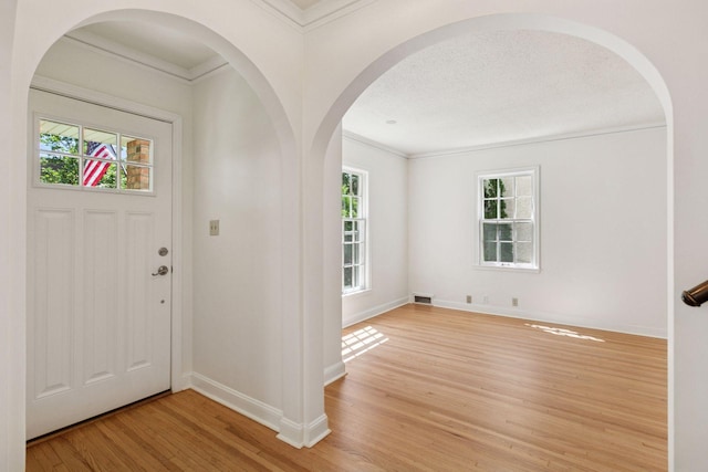 5620 Stevens Ave, Minneapolis, MN 55419 - entryway with light wood-style floors, ornamental molding, and arched walkways
