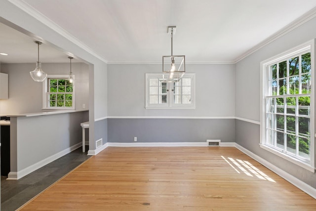 5620 Stevens Ave, Minneapolis, MN 55419 - unfurnished dining area featuring wood finished floors and crown molding