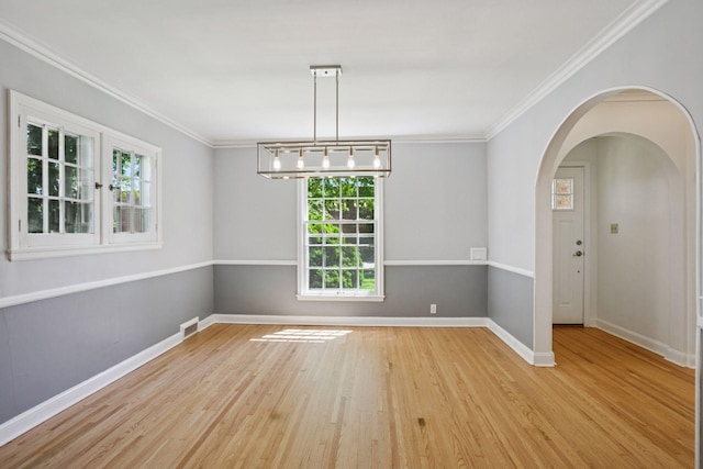 5620 Stevens Ave, Minneapolis, MN 55419 - spare room with plenty of natural light, wood finished floors, ornamental molding, and arched walkways