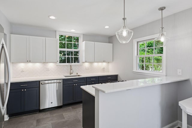 5620 Stevens Ave, Minneapolis, MN 55419 - kitchen featuring appliances with stainless steel finishes, white cabinets, decorative backsplash, light countertops, and recessed lighting