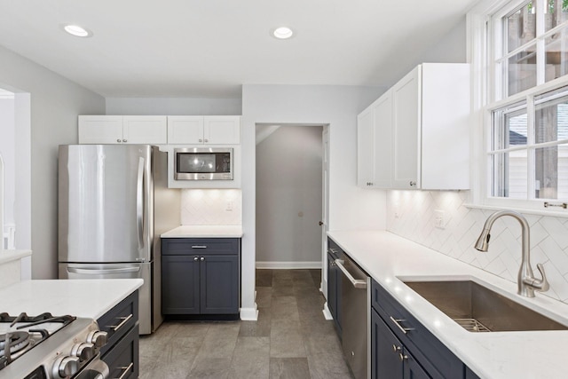 5620 Stevens Ave, Minneapolis, MN 55419 - kitchen featuring appliances with stainless steel finishes, white cabinetry, decorative backsplash, and recessed lighting