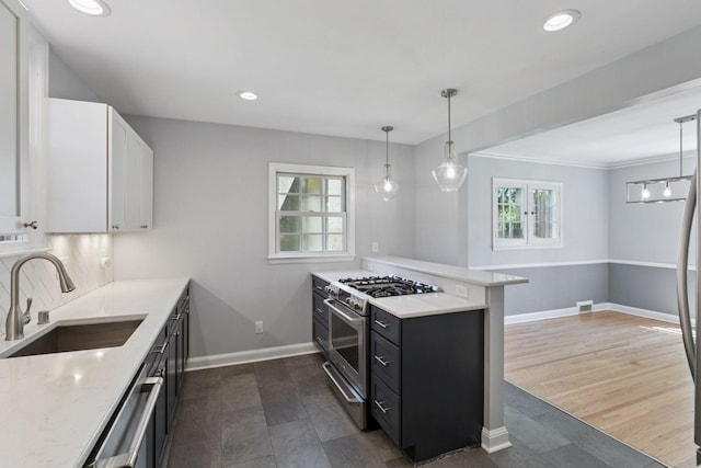 5620 Stevens Ave, Minneapolis, MN 55419 - kitchen with stainless steel appliances, white cabinetry, a peninsula, dark cabinets, and recessed lighting