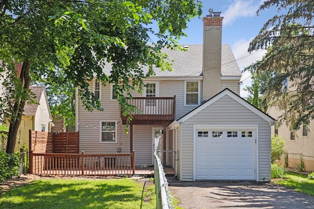 5620 Stevens Ave, Minneapolis, MN 55419 - rear view of house featuring asphalt driveway, a balcony, a chimney, a shingled roof, and a garage