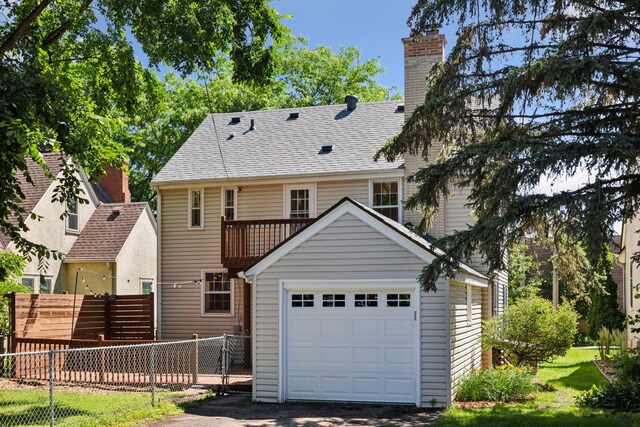 5620 Stevens Ave, Minneapolis, MN 55419 - back of house featuring a chimney, a garage, an outdoor structure, and a shingled roof