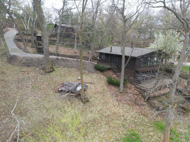 view of yard with stairs and a wooden deck