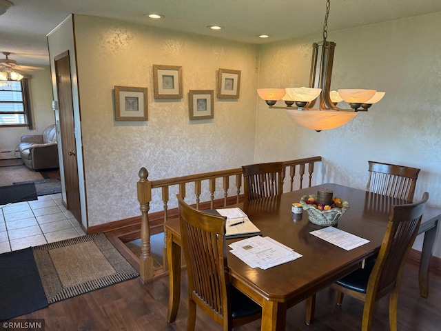 dining area featuring a ceiling fan, wood finished floors, baseboards, and a textured wall