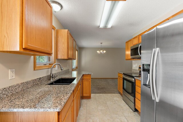 10773 Tamarack Cir NW, Coon Rapids, MN 55433 - kitchen featuring stainless steel appliances, a sink, a chandelier, light stone counters, and a textured ceiling