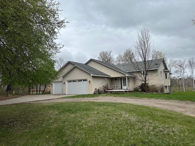 ranch-style home with an attached garage, a front lawn, and aphalt driveway