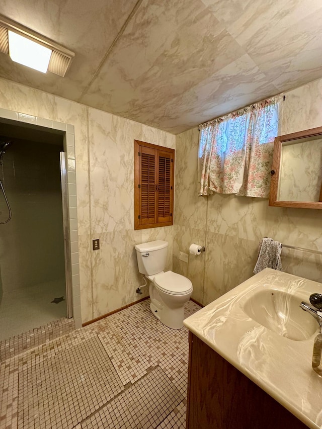 full bathroom with vanity, toilet, and a shower stall