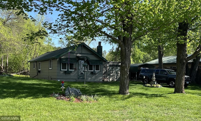 1219 Shore Dr, Luck, WI 54853 - view of front of house with a chimney and a front yard