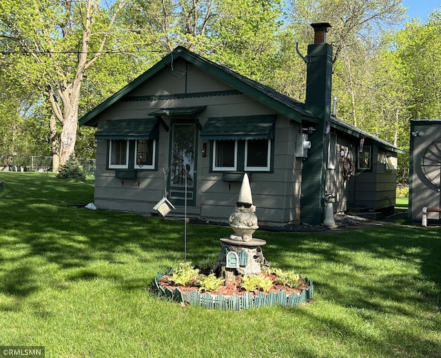 1219 Shore Dr, Luck, WI 54853 - view of front of property featuring a front lawn and a chimney