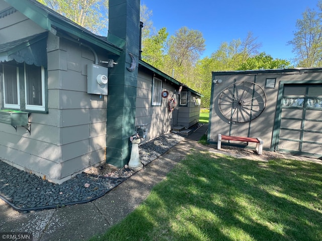 1219 Shore Dr, Luck, WI 54853 - view of side of home featuring a chimney and a yard