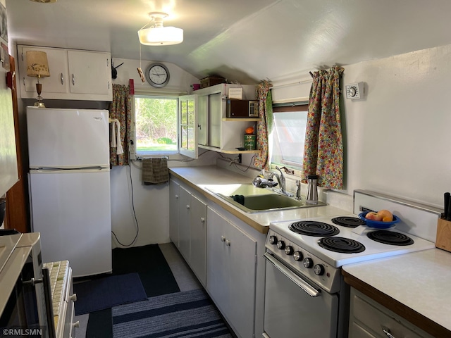 1219 Shore Dr, Luck, WI 54853 - kitchen with white appliances, a sink, vaulted ceiling, light countertops, and white cabinets