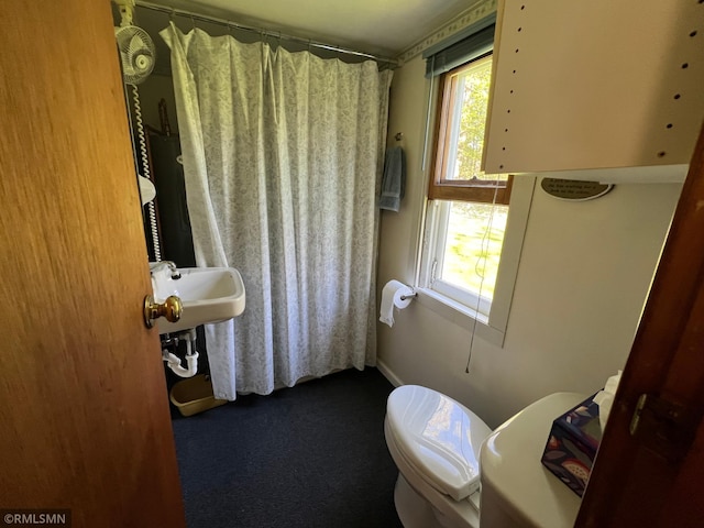 1219 Shore Dr, Luck, WI 54853 - bathroom featuring toilet, a shower with curtain, and baseboards
