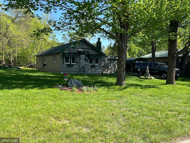 1219 Shore Dr, Luck, WI 54853 - view of front of house featuring a chimney and a front lawn