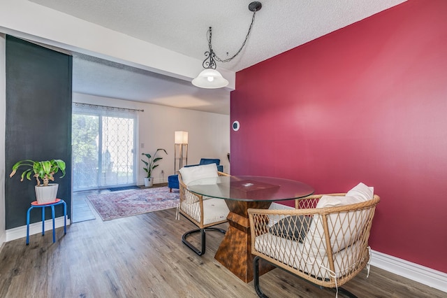 465 Dorland Ct S, Maplewood, MN 55119 - dining space featuring baseboards, a textured ceiling, and wood finished floors