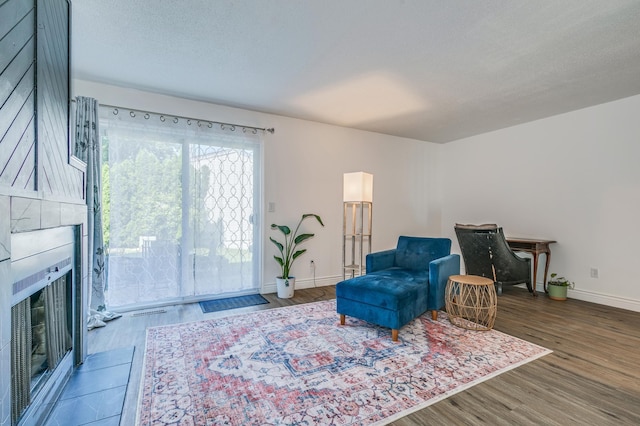 465 Dorland Ct S, Maplewood, MN 55119 - living area with baseboards, wood finished floors, and a large fireplace