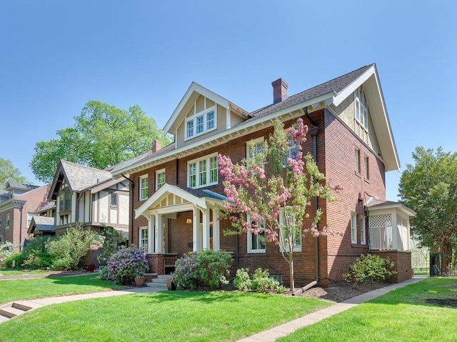 760 Linwood Ave, Saint Paul, MN 55105 - view of front of property with brick siding, a chimney, and a front yard