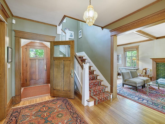 760 Linwood Ave, Saint Paul, MN 55105 - entrance foyer featuring wood-type flooring, stairway, crown molding, and a chandelier