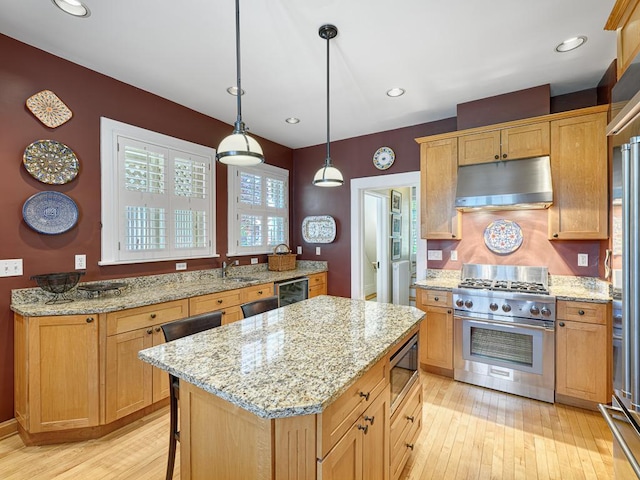 760 Linwood Ave, Saint Paul, MN 55105 - kitchen with appliances with stainless steel finishes, under cabinet range hood, wine cooler, light wood-style flooring, and a sink