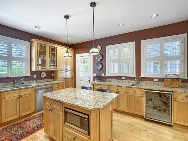760 Linwood Ave, Saint Paul, MN 55105 - kitchen with appliances with stainless steel finishes, a sink, beverage cooler, light wood-type flooring, and recessed lighting