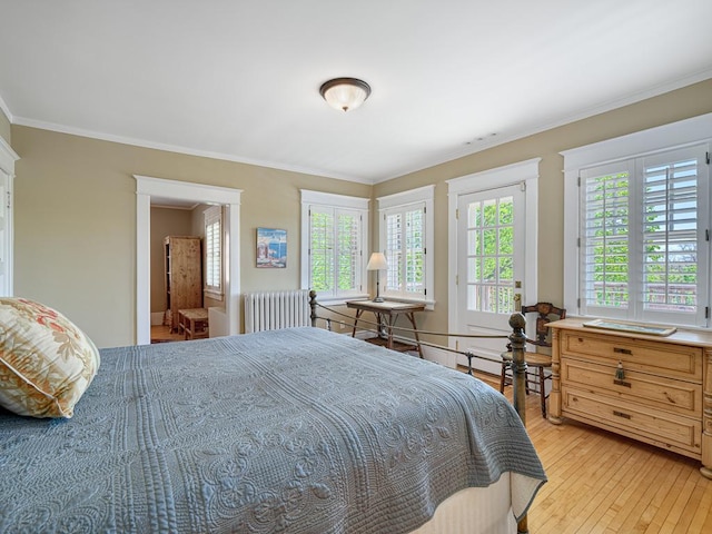 760 Linwood Ave, Saint Paul, MN 55105 - bedroom featuring radiator heating unit, multiple windows, light wood finished floors, and ornamental molding