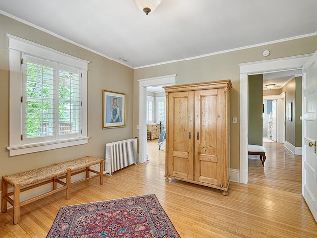 760 Linwood Ave, Saint Paul, MN 55105 - hallway with radiator heating unit, light wood-style floors, crown molding, and baseboards
