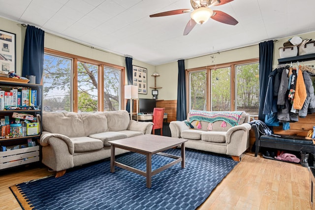 living room featuring a ceiling fan and wood finished floors