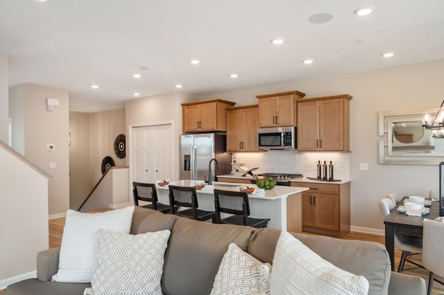 6758 Wildflower Way, Minnetrista, MN 55331 - kitchen featuring stainless steel appliances, light countertops, baseboards, backsplash, and open floor plan