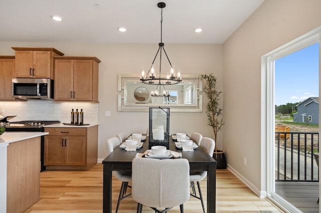 6758 Wildflower Way, Minnetrista, MN 55331 - dining space featuring healthy amount of natural light, light wood-style flooring, a chandelier, baseboards, and recessed lighting