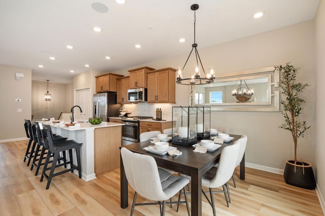 6758 Wildflower Way, Minnetrista, MN 55331 - dining space featuring a chandelier, light wood finished floors, baseboards, and recessed lighting