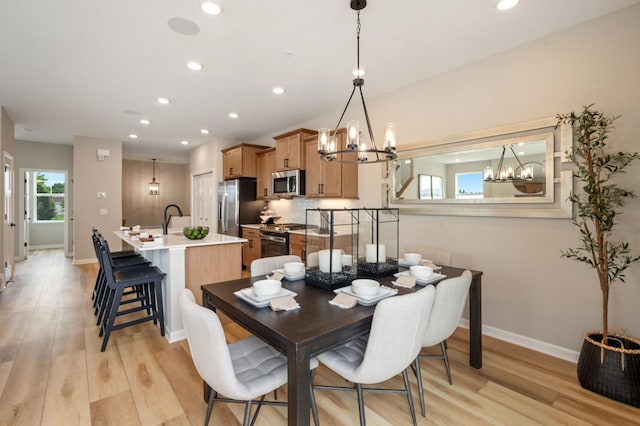 6758 Wildflower Way, Minnetrista, MN 55331 - dining area featuring a chandelier, light wood finished floors, recessed lighting, and baseboards