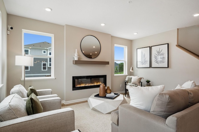 6758 Wildflower Way, Minnetrista, MN 55331 - carpeted living area with a glass covered fireplace, baseboards, and recessed lighting
