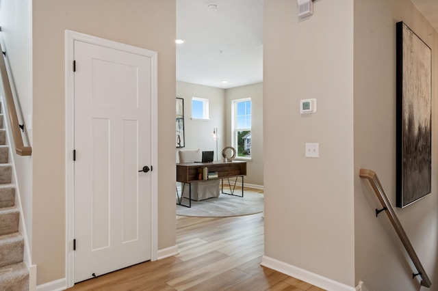 6758 Wildflower Way, Minnetrista, MN 55331 - hallway with light wood-type flooring, baseboards, and a desk